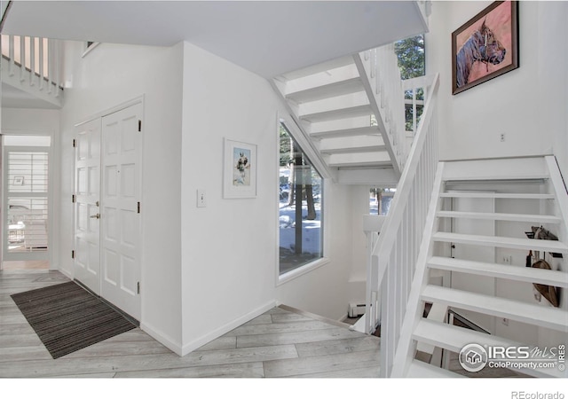 stairway with hardwood / wood-style floors