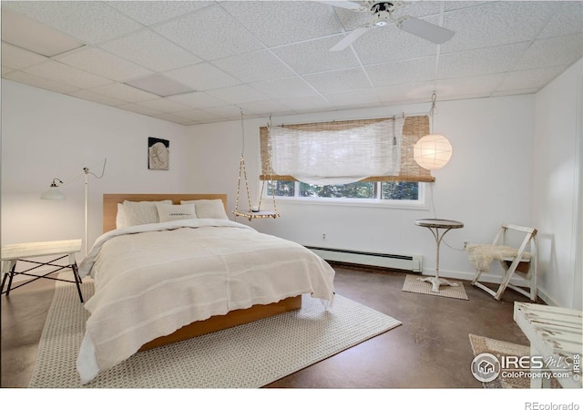 bedroom featuring ceiling fan, a baseboard radiator, and a paneled ceiling