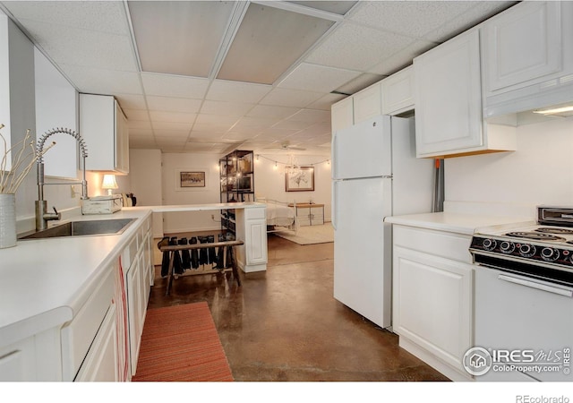 kitchen with white cabinetry, sink, white appliances, and a paneled ceiling