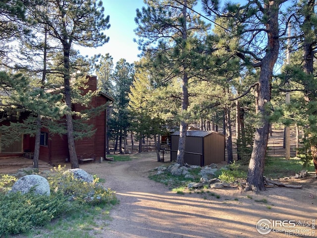 view of gate featuring a storage unit