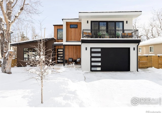 contemporary house featuring a balcony and a garage