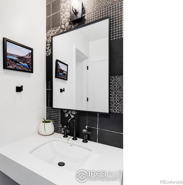 bathroom featuring vanity and backsplash