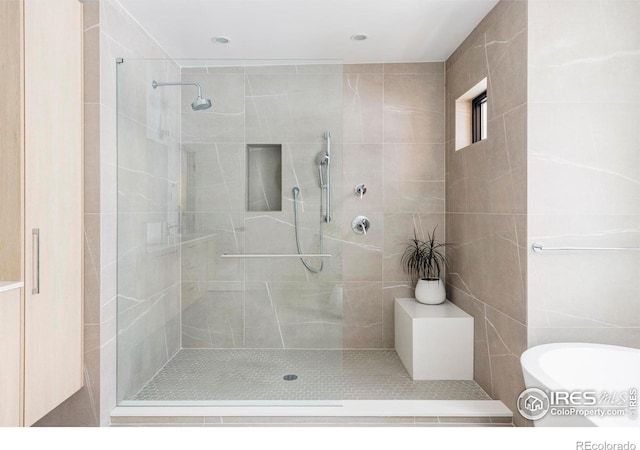 bathroom featuring separate shower and tub