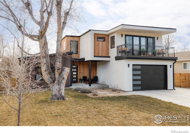 modern home featuring stucco siding, a front lawn, concrete driveway, a garage, and a balcony