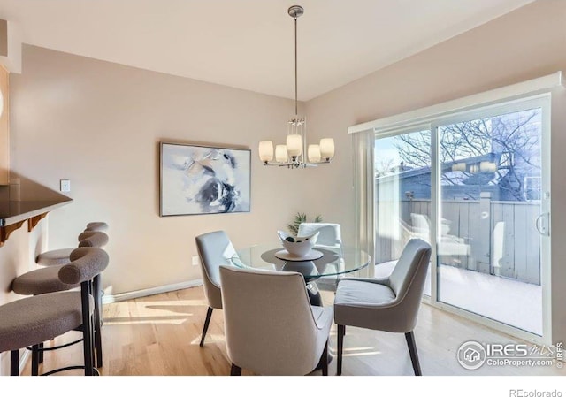 dining area featuring an inviting chandelier and light hardwood / wood-style floors