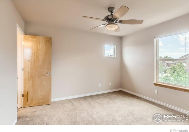 carpeted empty room with ceiling fan