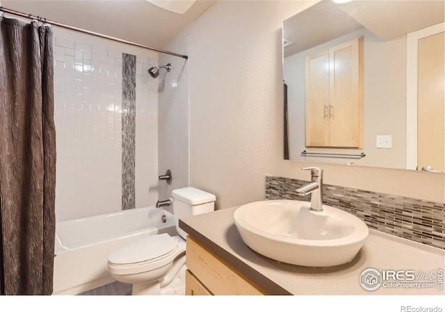 full bathroom featuring vanity, backsplash, toilet, and shower / bath combo