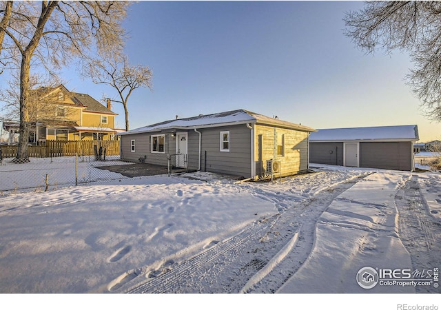 view of front of home featuring a garage and an outdoor structure