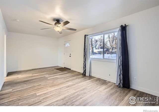 spare room featuring light hardwood / wood-style floors and ceiling fan