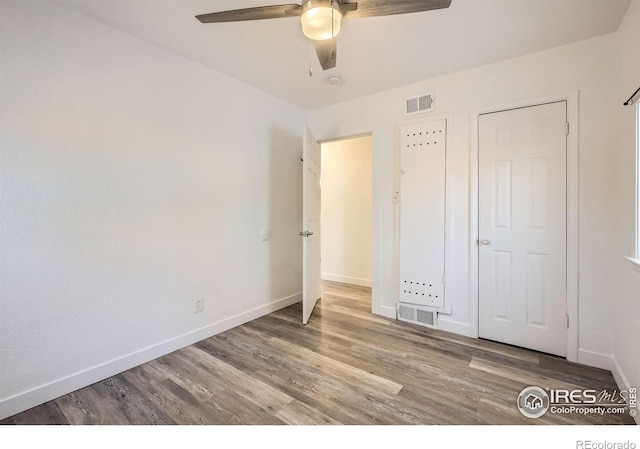 unfurnished bedroom featuring hardwood / wood-style flooring and ceiling fan