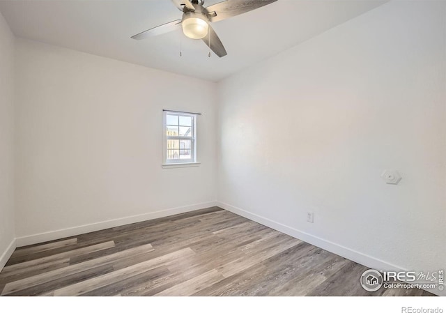 unfurnished room with hardwood / wood-style floors and ceiling fan