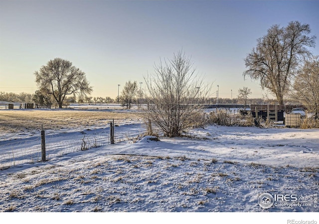 yard layered in snow featuring a rural view