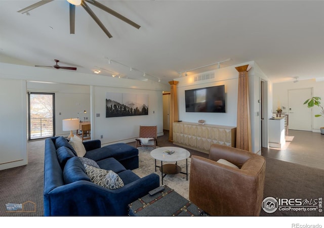 carpeted living room with rail lighting, lofted ceiling, and ceiling fan