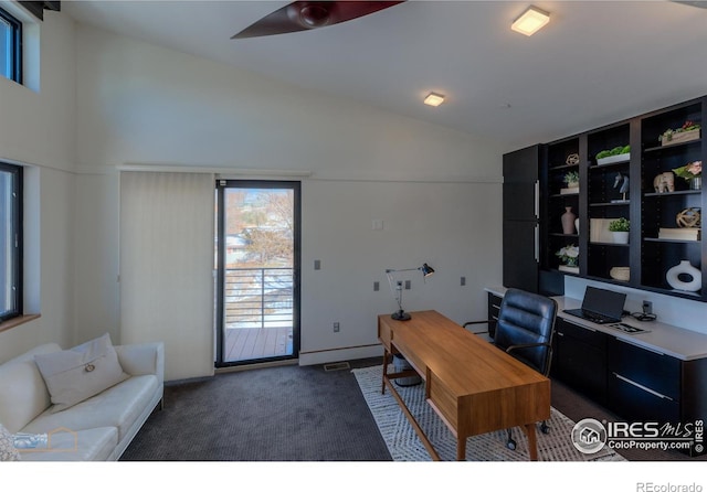 carpeted office space featuring ceiling fan and vaulted ceiling