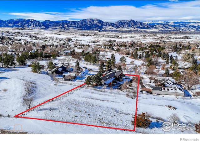 snowy aerial view featuring a mountain view