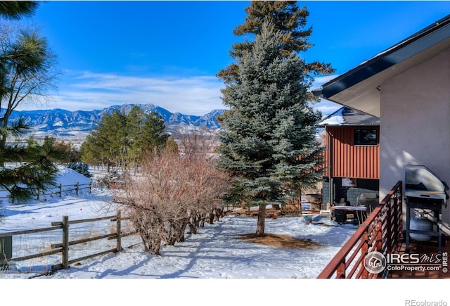 snowy yard with a mountain view