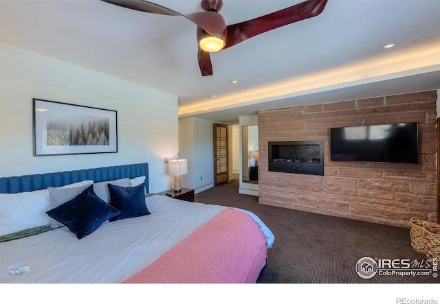 bedroom featuring dark colored carpet and ceiling fan