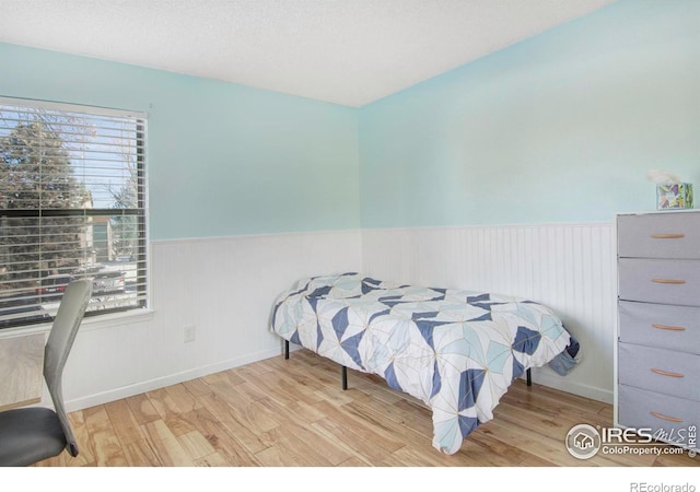 bedroom featuring light hardwood / wood-style floors and multiple windows