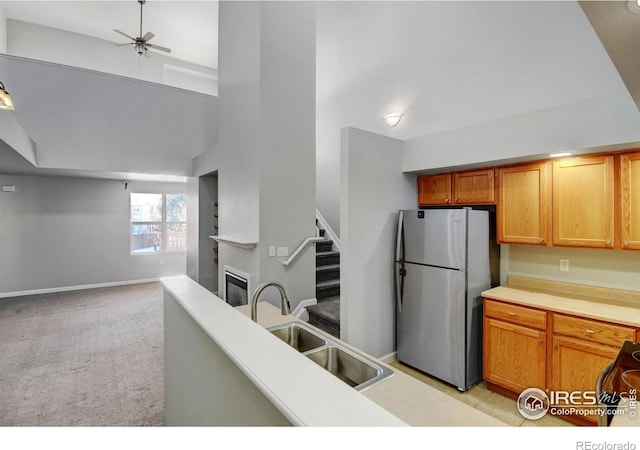 kitchen featuring sink, light colored carpet, stainless steel fridge, and ceiling fan