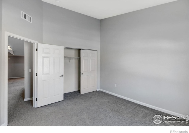 unfurnished bedroom featuring carpet flooring and a closet