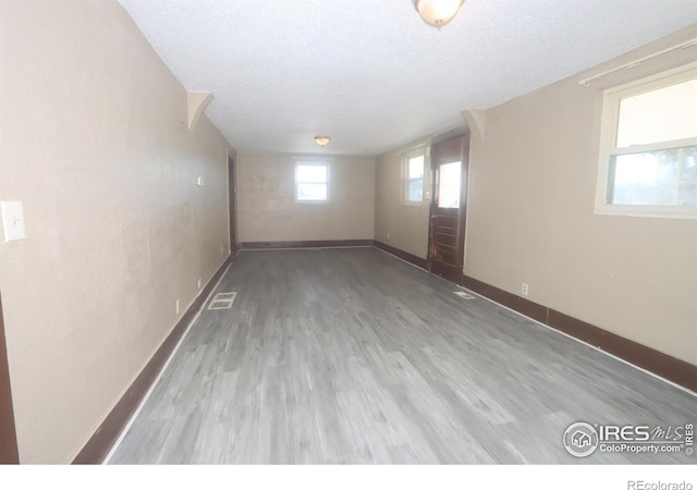 empty room featuring hardwood / wood-style floors and a textured ceiling