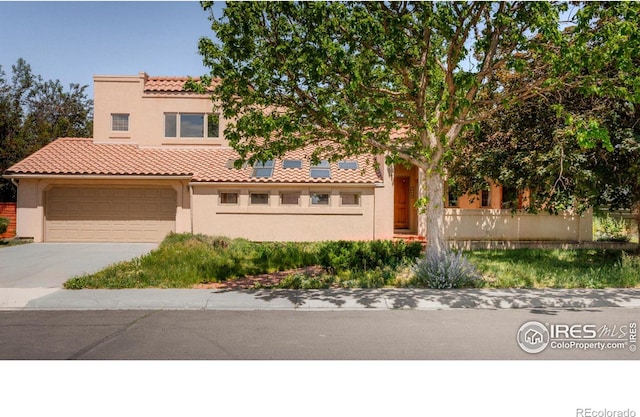 mediterranean / spanish-style house with a garage