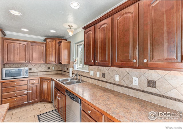 kitchen featuring sink, crown molding, appliances with stainless steel finishes, light tile patterned flooring, and decorative backsplash