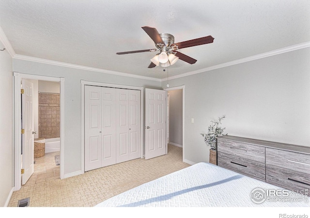 bedroom featuring a closet, ornamental molding, ceiling fan, and ensuite bath