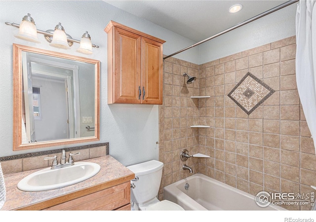 full bathroom with shower / tub combo with curtain, vanity, and toilet