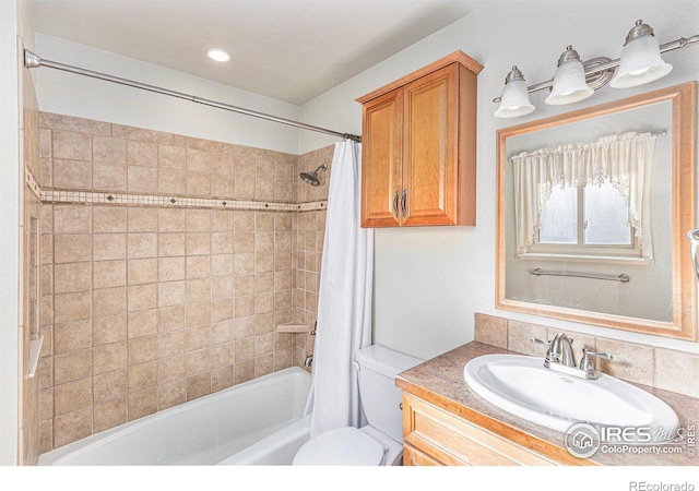 full bathroom with vanity, shower / bath combination with curtain, and toilet