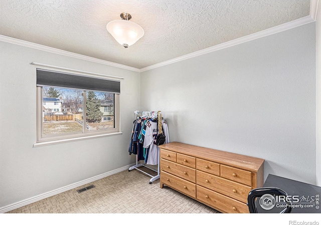 interior space featuring crown molding and a textured ceiling