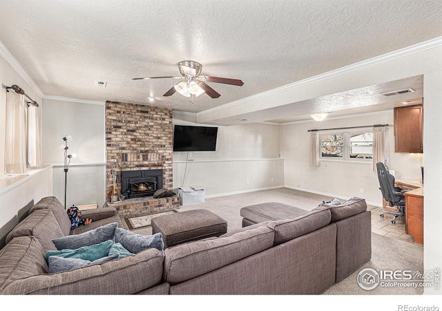 carpeted living room with crown molding, a brick fireplace, ceiling fan, and a textured ceiling