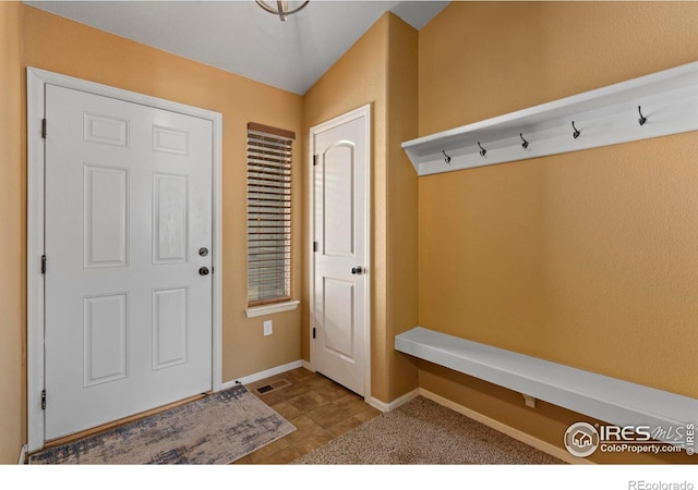 mudroom featuring lofted ceiling