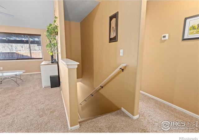 stairs with vaulted ceiling and carpet