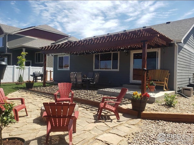 rear view of house with a pergola and a patio