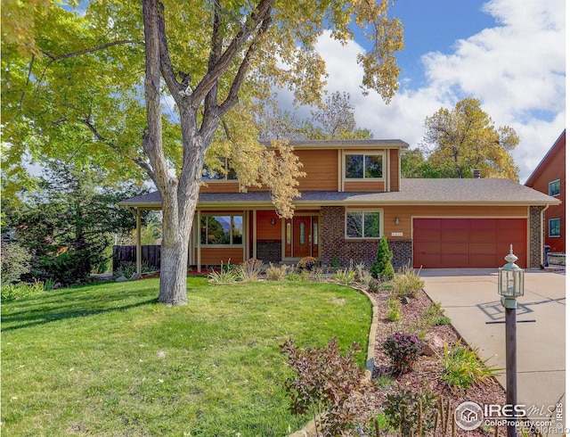 view of front of property featuring a garage and a front lawn