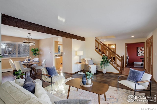 living room featuring dark hardwood / wood-style flooring, a chandelier, and beamed ceiling