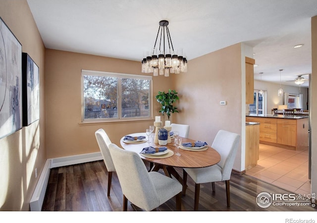 dining room featuring wood-type flooring and an inviting chandelier