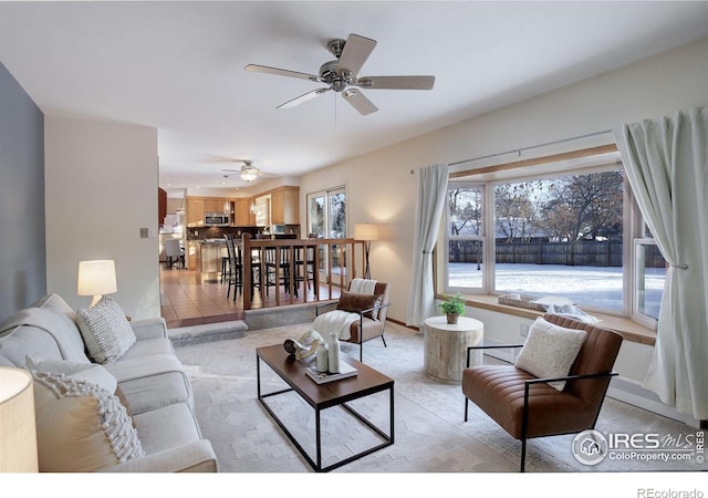 tiled living room with ceiling fan