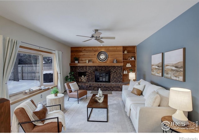 living room featuring a fireplace and ceiling fan