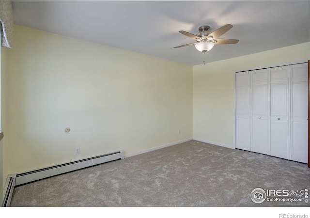 unfurnished bedroom with ceiling fan, light colored carpet, a closet, and a baseboard heating unit