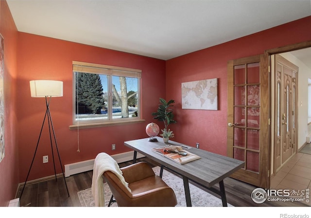 office space featuring dark wood-type flooring and baseboard heating