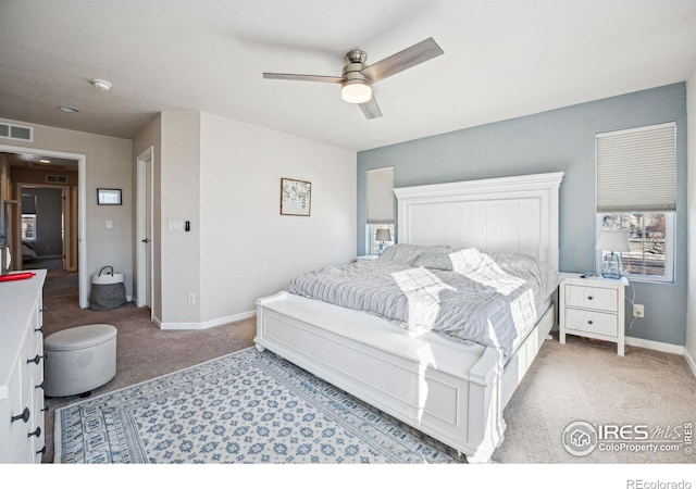 bedroom featuring light carpet and ceiling fan