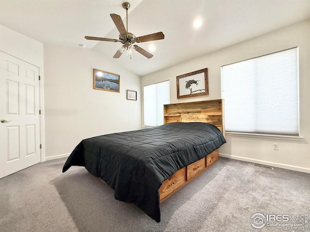 bedroom with vaulted ceiling, light colored carpet, and ceiling fan