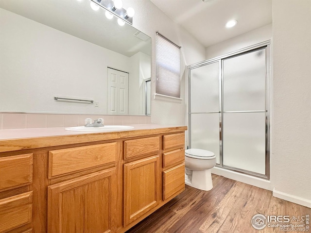 bathroom with vanity, an enclosed shower, wood-type flooring, and toilet