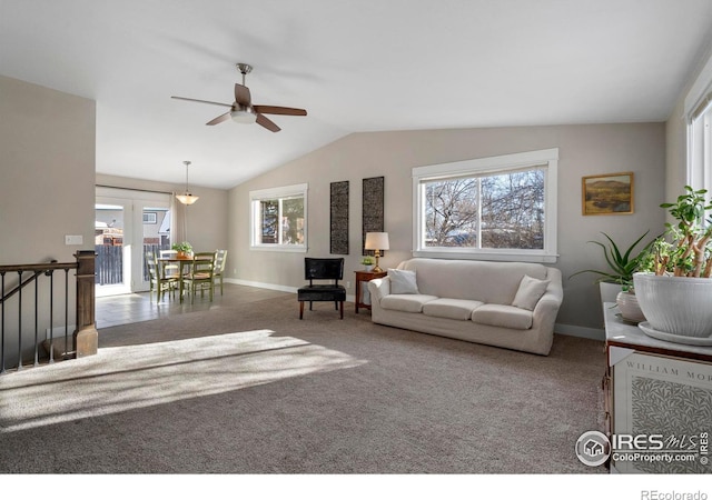 living room with vaulted ceiling, carpet flooring, and a wealth of natural light