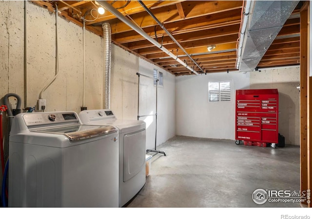 clothes washing area featuring separate washer and dryer