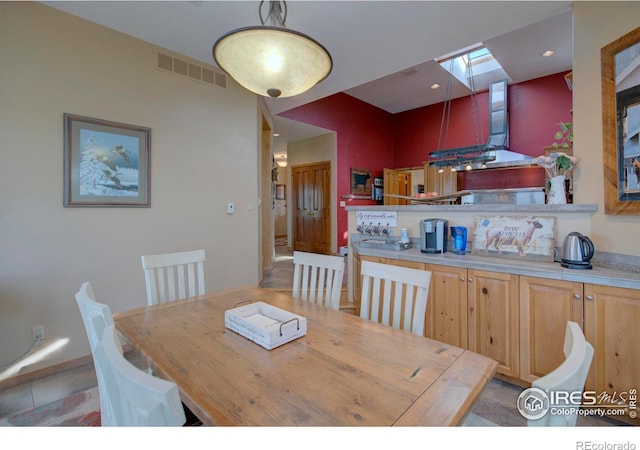 dining space featuring a skylight