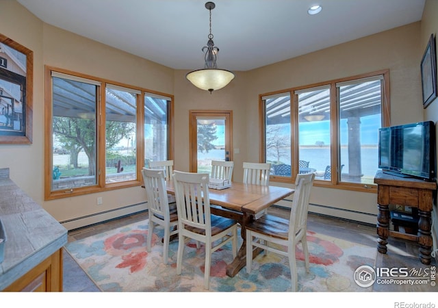 dining space featuring baseboard heating and a wealth of natural light