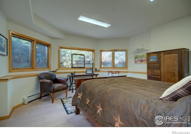 bedroom featuring a baseboard radiator and light carpet